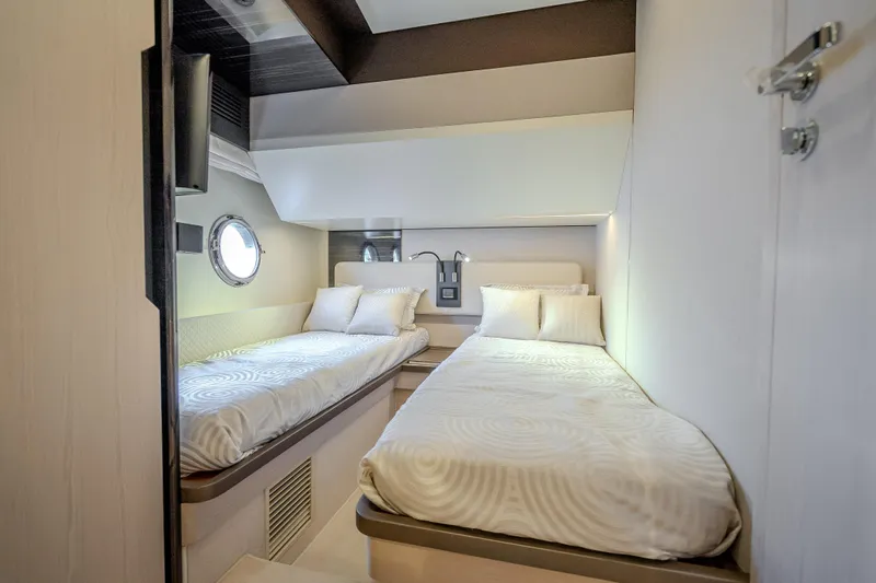  Yacht Photos Pics Luxurious twin cabin interior on 2019 Azimut 66 yacht, featuring modern design and cozy bedding.