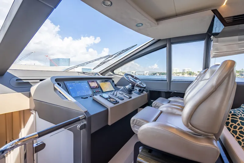  Yacht Photos Pics Luxurious 2019 Azimut 66 yacht cockpit with modern navigation controls and leather seating.