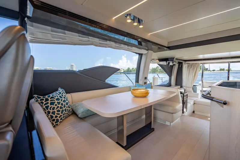  Yacht Photos Pics Luxurious interior of 2019 Azimut 66 yacht with elegant dining area and scenic views.