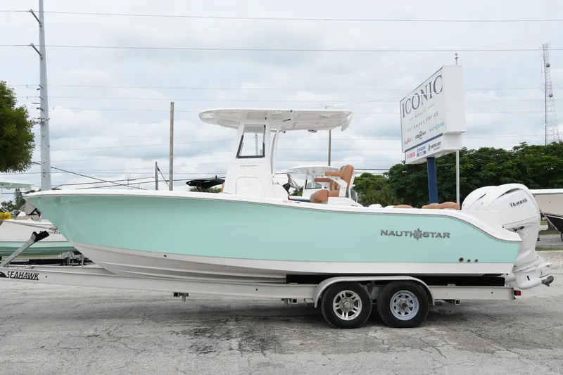  Yacht Photos Pics 2025 NauticStar 252 Legacy boat on trailer, displayed outdoors.