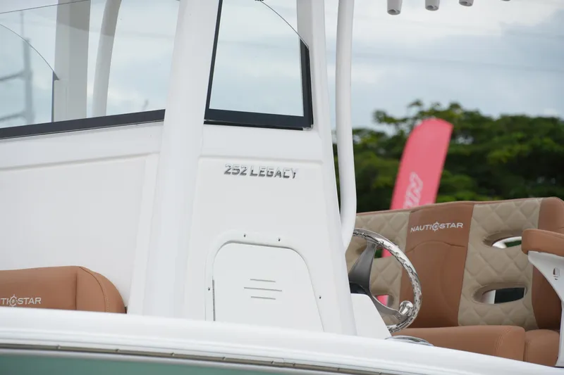  Yacht Photos Pics 2025 NauticStar 252 Legacy boat interior with tan seating and steering wheel.