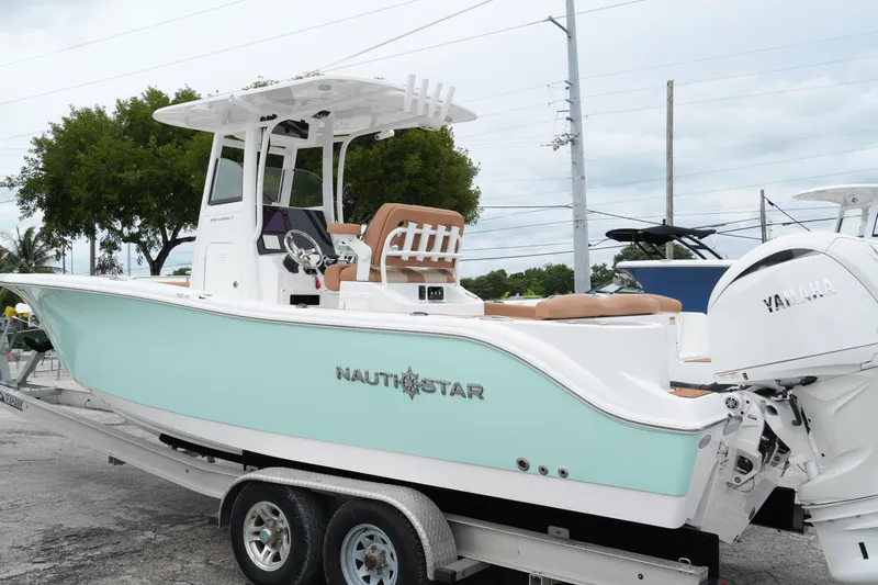 Yacht Photos Pics 2025 NauticStar 252 Legacy boat on trailer with Yamaha engine, mint green hull.