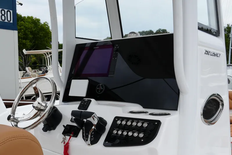  Yacht Photos Pics 2025 NauticStar 252 Legacy boat dashboard with steering wheel and control panel.