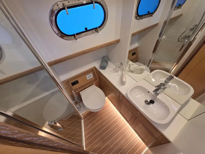  Yacht Photos Pics Luxurious bathroom in 2025 Sasga Yachts Menorquin 48, featuring modern fixtures and elegant wood accents.