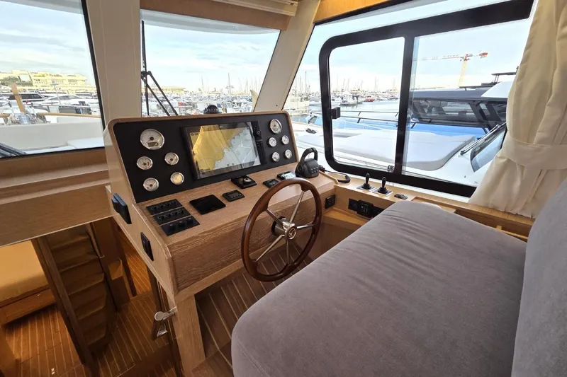  Yacht Photos Pics 2025 Sasga Yachts Menorquin 48 helm with navigation instruments and wooden steering wheel.