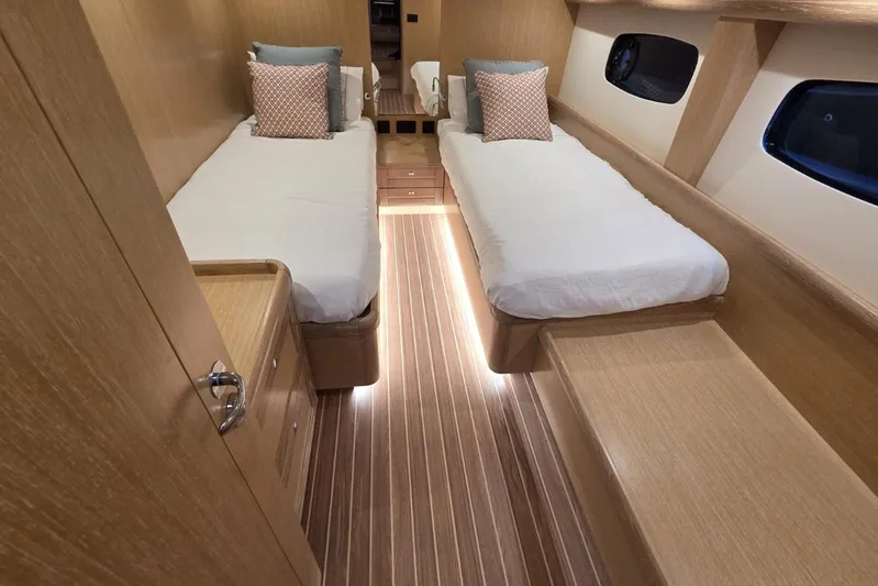  Yacht Photos Pics Luxurious cabin interior of 2025 Sasga Yachts Menorquin 48 with twin beds and elegant wood finish.