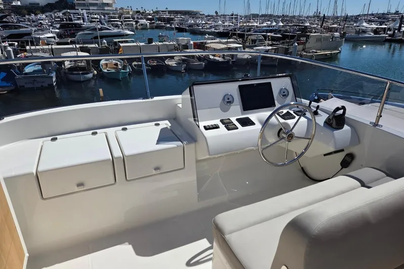  Yacht Photos Pics Helm of 2025 Sasga Yachts Menorquin 48 overlooking marina with numerous boats.