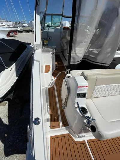  Yacht Photos Pics 2018 Chaparral 310 Signature boat interior with teak flooring and seating area.