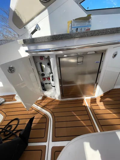  Yacht Photos Pics 2018 Chaparral 310 Signature boat interior with wood flooring and stainless steel appliances.