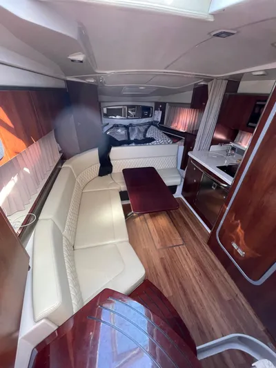  Yacht Photos Pics 2018 Chaparral 310 Signature interior with elegant seating, wooden flooring, and modern kitchen amenities.