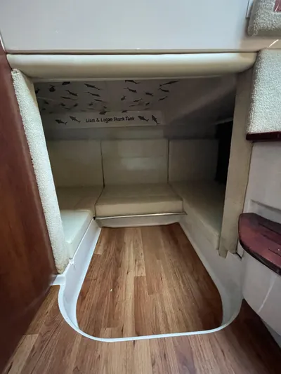  Yacht Photos Pics 2018 Chaparral 310 Signature cabin interior with wood flooring and cushioned seating.