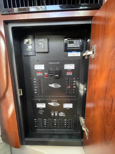  Yacht Photos Pics Electrical panel inside 2018 Chaparral 310 Signature boat, featuring circuit breakers and controls.