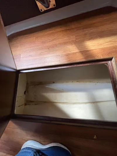  Yacht Photos Pics Empty storage compartment on 2018 Chaparral 310 Signature boat with wooden flooring.