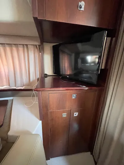  Yacht Photos Pics 2018 Chaparral 310 Signature interior with TV and wooden cabinetry.