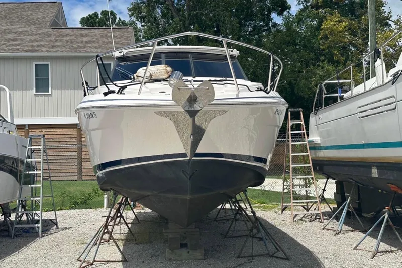  Yacht Photos Pics 2020 Regal 35 Sport Coupe boat on stands, parked outdoors near a house.