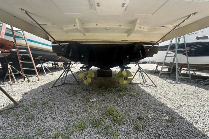  Yacht Photos Pics 2020 Regal 35 Sport Coupe boat undercarriage with dual propellers on gravel.