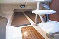 2024 Quicksilver 805 Open cabin interior with wooden flooring and seating.