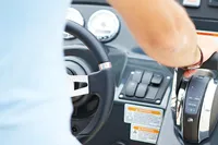 Person operating 2024 Quicksilver 805 Open boat controls.