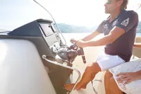 Man steering 2024 Quicksilver 805 Open boat on a sunny day.