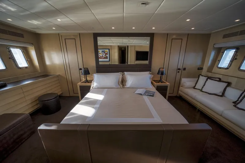 Manu Yacht Photos Pics Luxurious bedroom interior of a 2006 Mangusta 92 yacht with elegant furnishings.