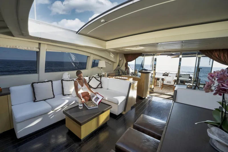 Manu Yacht Photos Pics Luxurious interior of 2006 Mangusta 92 yacht with ocean view and elegant seating area.