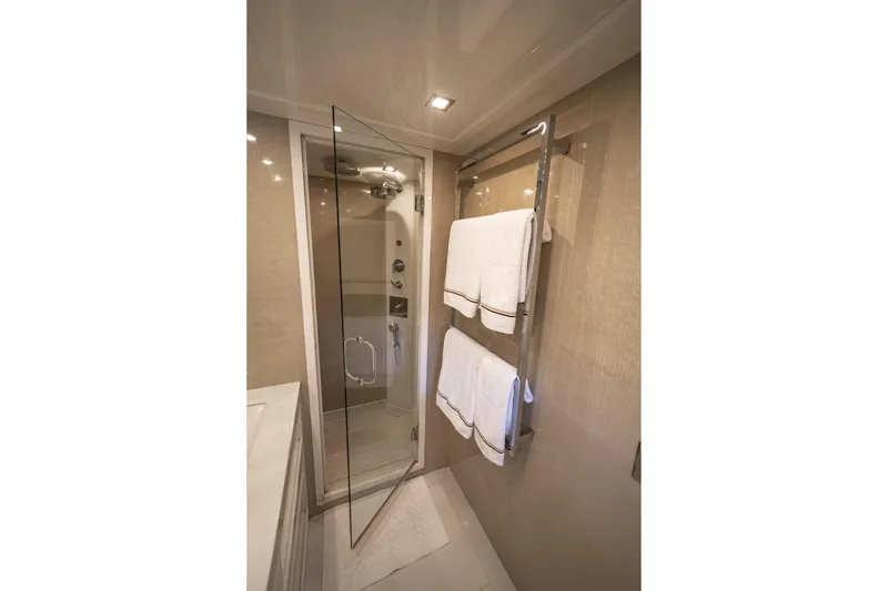 Manu Yacht Photos Pics Luxurious bathroom in 2006 Mangusta 92 yacht with glass shower and towel rack.