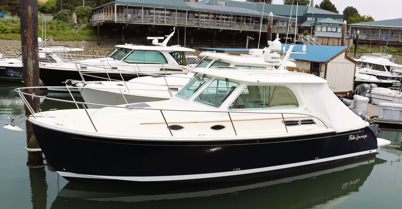 Polo Lounge Yacht Photos Pics 2020 Back Cove 34O boat docked in marina, featuring sleek design and modern amenities.