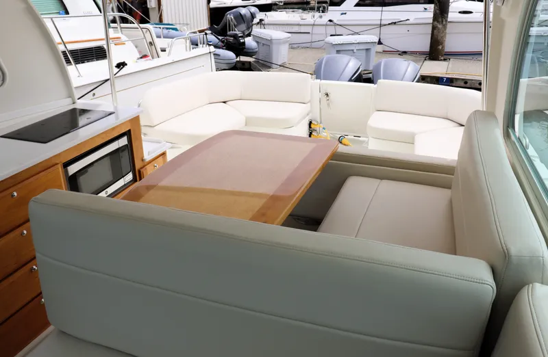 Polo Lounge Yacht Photos Pics Luxurious interior of 2020 Back Cove 34O yacht with seating and dining area.