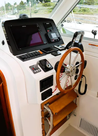 Polo Lounge Yacht Photos Pics Helm of 2020 Back Cove 34O boat with steering wheel and navigation controls.