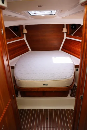 Polo Lounge Yacht Photos Pics 2020 Back Cove 34O cabin interior with wooden finish and cozy bed.