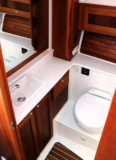 Polo Lounge Yacht Photos Pics Luxurious bathroom in 2020 Back Cove 34O yacht with wooden cabinetry and modern fixtures.
