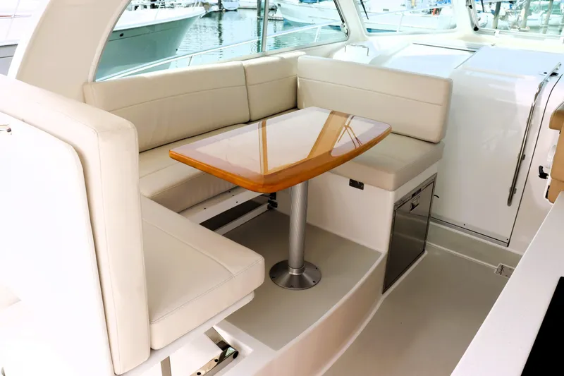 Polo Lounge Yacht Photos Pics Luxurious seating area on a 2020 Back Cove 34O yacht with elegant wooden table.