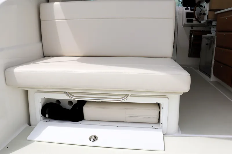 Polo Lounge Yacht Photos Pics 2020 Back Cove 34O boat interior with cushioned seating and storage compartment.
