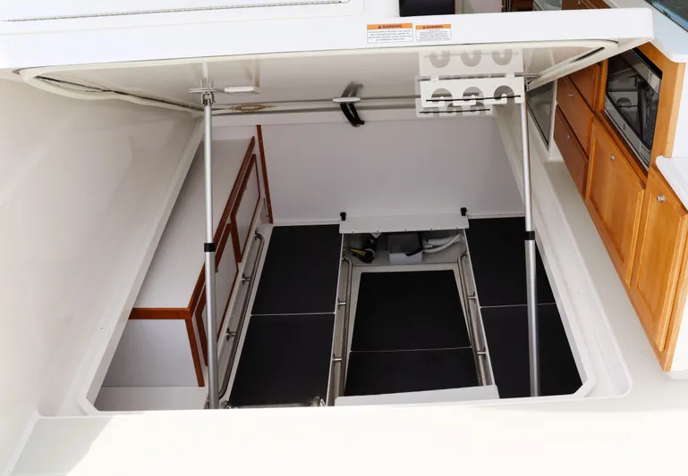 Polo Lounge Yacht Photos Pics 2020 Back Cove 34O yacht interior with open hatch and wooden cabinetry.