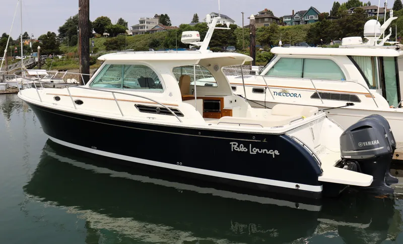 Polo Lounge Yacht Photos Pics 2020 Back Cove 34O boat docked, featuring sleek design and Yamaha outboard motor.
