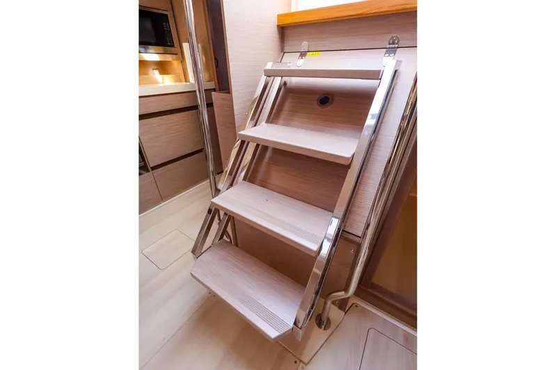  Yacht Photos Pics Interior stairs of 2025 Hanse 458 yacht, featuring sleek wooden design and modern finish.