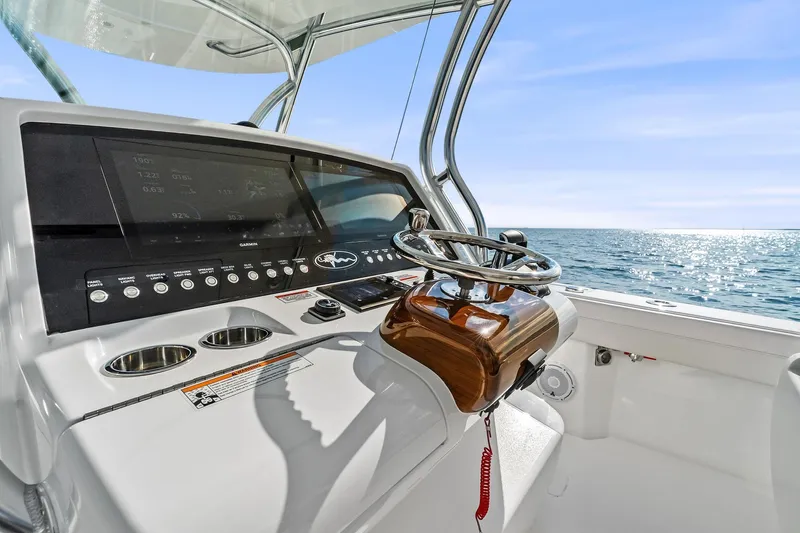 New Valhalla Boatworks V-33 Yacht Photos Pics 2026 Valhalla Boatworks V-33 helm with ocean view, featuring modern controls and steering wheel.