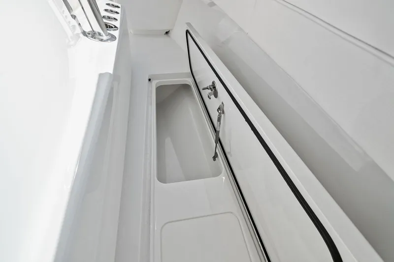 New Valhalla Boatworks V-33 Yacht Photos Pics 2026 Valhalla Boatworks V-33 storage compartment with sleek white interior design.