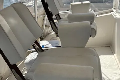  Yacht Photos Pics Interior seating of 2008 Viking 52 Convertible yacht, featuring white cushioned chairs.