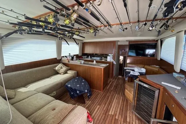  Yacht Photos Pics Interior of 2008 Viking 52 Convertible yacht with fishing rods and cozy seating area.