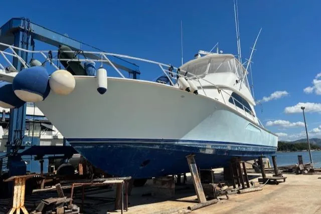  Yacht Photos Pics 2008 Viking 52 Convertible yacht on dry dock, blue hull, clear sky background.