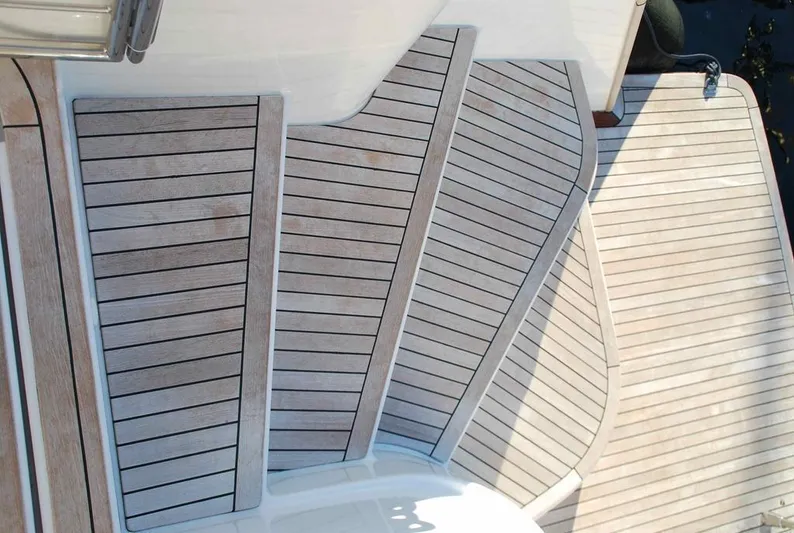  Yacht Photos Pics Teak deck of 2011 Fountaine Pajot Queensland 55 yacht, showcasing elegant wood finish.