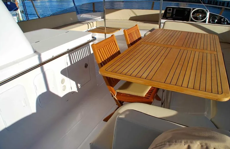  Yacht Photos Pics Luxurious deck of 2011 Fountaine Pajot Queensland 55 with wooden table and chairs.