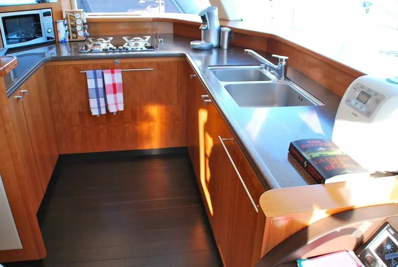  Yacht Photos Pics Modern kitchen interior of 2011 Fountaine Pajot Queensland 55 yacht with wooden cabinetry.