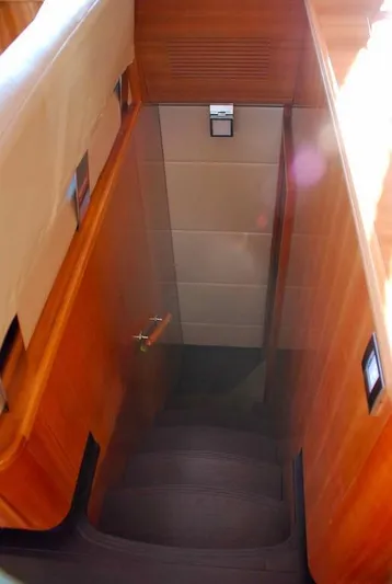  Yacht Photos Pics Staircase inside 2011 Fountaine Pajot Queensland 55 yacht, featuring wooden paneling and modern design.