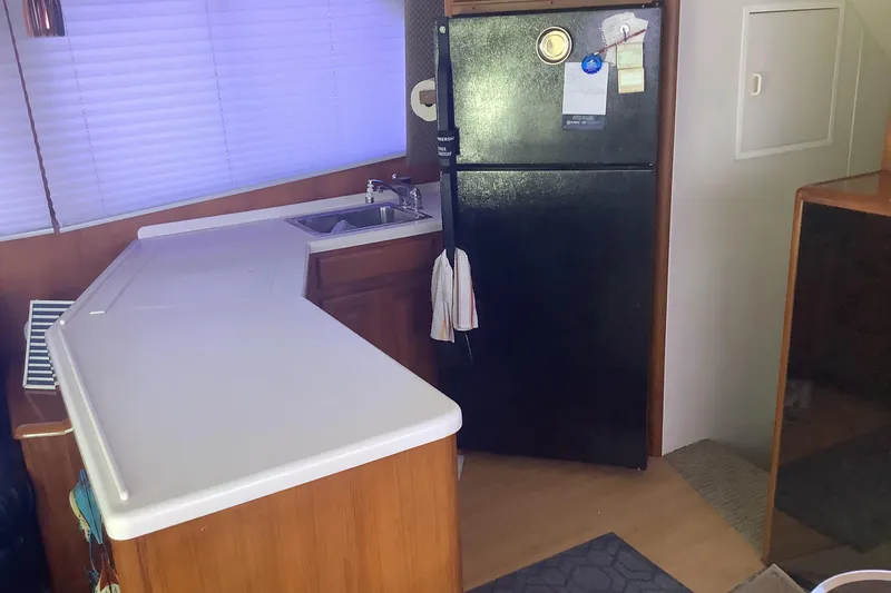 Fourth Quarter Yacht Photos Pics 1994 Viking 50' Convertible Sportfish kitchen with counter, sink, and black refrigerator.