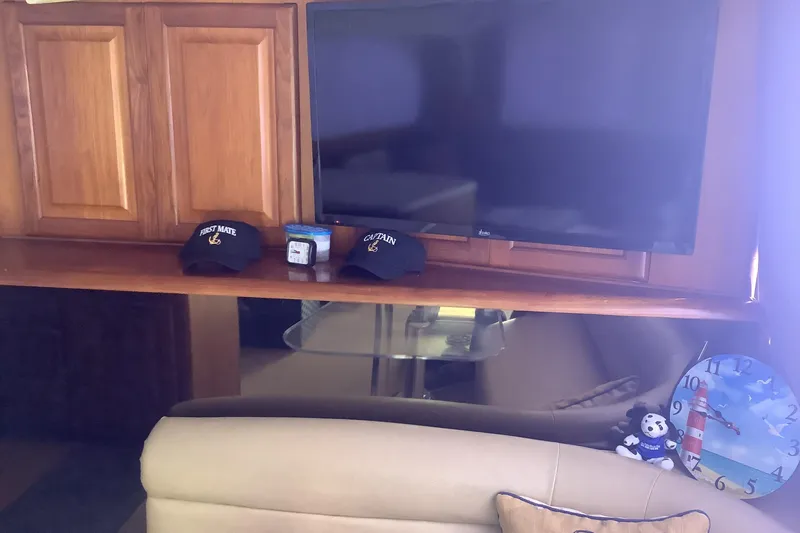 Fourth Quarter Yacht Photos Pics Interior of 1994 Viking 50' Convertible Sportfish with TV, hats, and nautical decor.