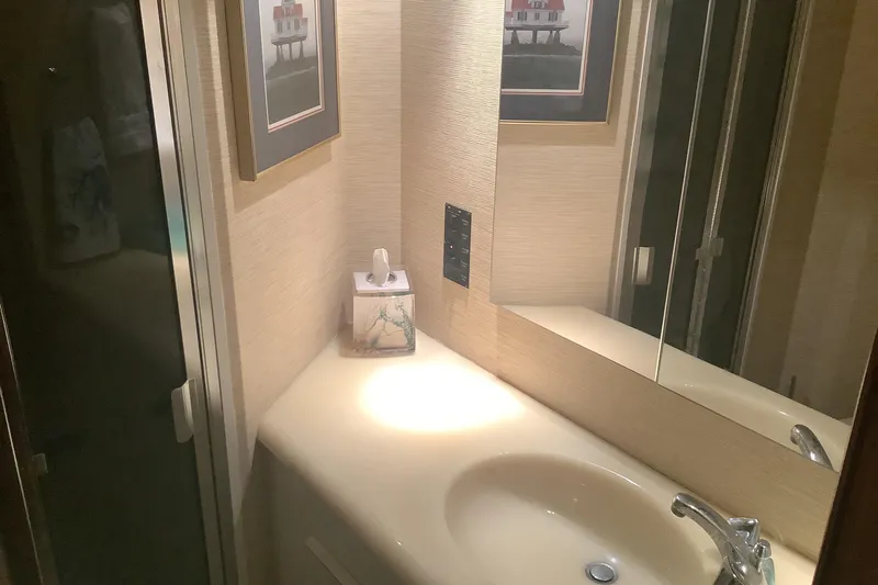 Fourth Quarter Yacht Photos Pics Bathroom interior of 1994 Viking 50' Convertible Sportfish yacht with sink and mirror.