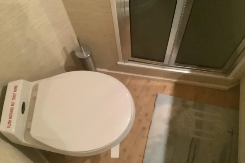 Fourth Quarter Yacht Photos Pics Bathroom interior of 1994 Viking 50' Convertible Sportfish yacht, featuring toilet and shower.