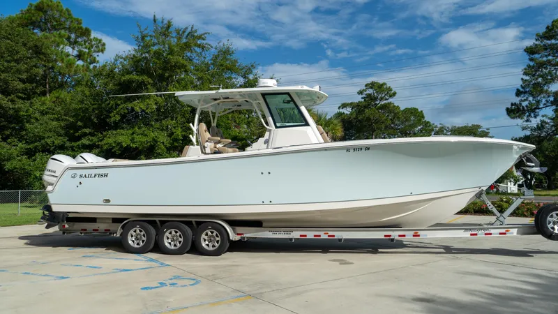  Yacht Photos Pics 2020 Sailfish 360 CC boat on a trailer, parked outdoors.
